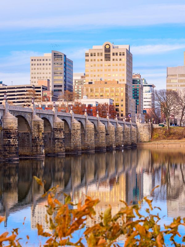Harrisburg, Pennsylvania, USA skyline on the Susquehanna River with fall foliage.